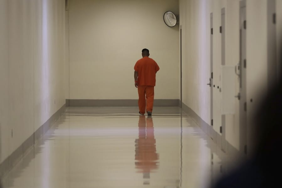 A detainee walks in a hallway during a media tour at the U.S. Immigration and Customs Enforcement (ICE) detention facility Tuesday, Sept. 10, 2019, in Tacoma, Wash. (AP Photo/Ted S.