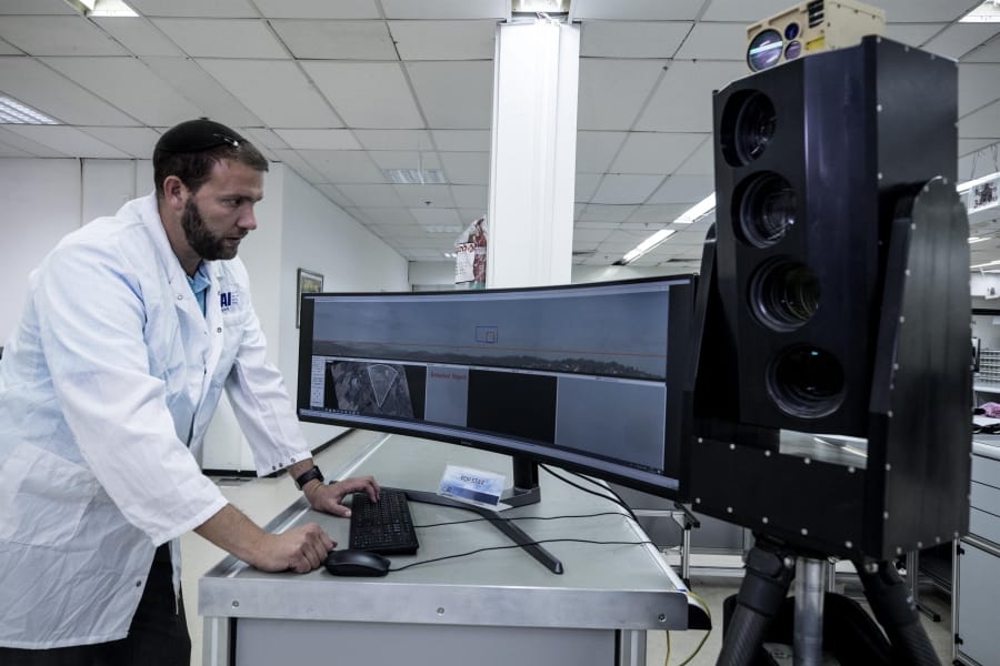 In this Monday, Sept. 9, 2019 photo, Ariel Gomez, a systems engineer at Israel Aerospace Industries, works on the Popstar system that can track and identify flying objects day or night without being detected, at Israel Aerospace Industries, in the Israeli town of Yehud near Tel Aviv. Israel has long been a dominant player in the military drone export business, developing small attack aircraft as well as long-range spy planes. Now, Israeli firms are at the forefront of a global industry developing means to protect against the drone threat.