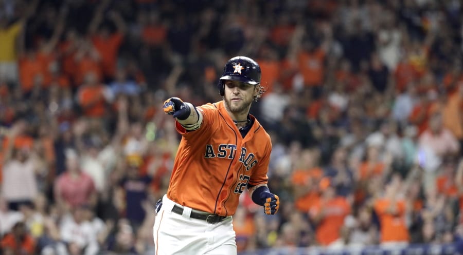 Houston Astros’ Josh Reddick points to the dugout after hitting a home run against the Seattle Mariners during the fourth inning of a baseball game Friday, Sept. 6, 2019, in Houston. (AP Photo/David J.