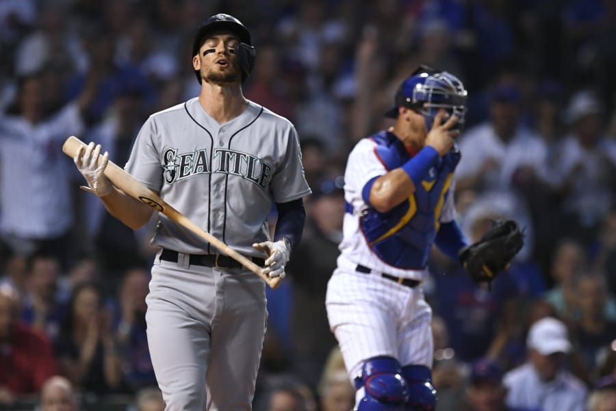 Seattle Mariners’ Ryan Court left, reacts after striking out, next to Chicago Cubs catcher Willson Contreras during the first inning of a baseball game Tuesday, Sept. 3, 2019, in Chicago.