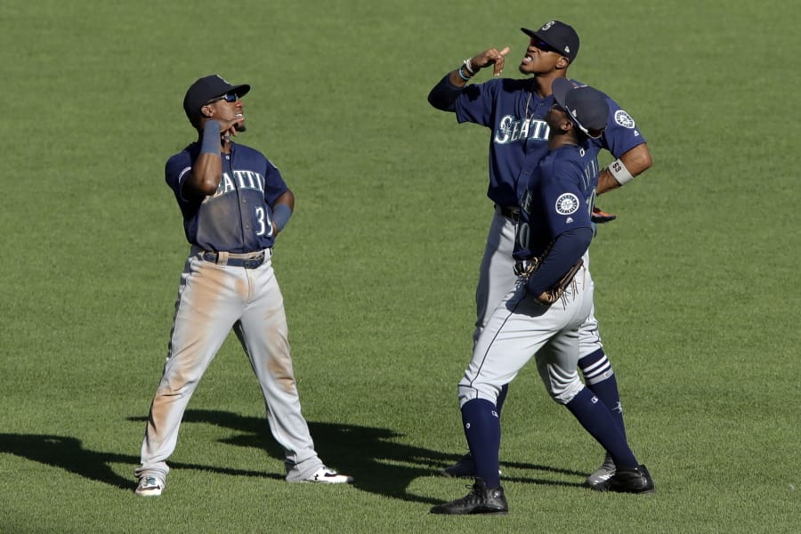 Seattle Mariners outfielders Shed Long (39), Keon Broxton, right rear, and Kyle Lewis, front right, celebrate a win over the Pittsburgh Pirates on Thursdaty in Pittsburgh. (Gene J.