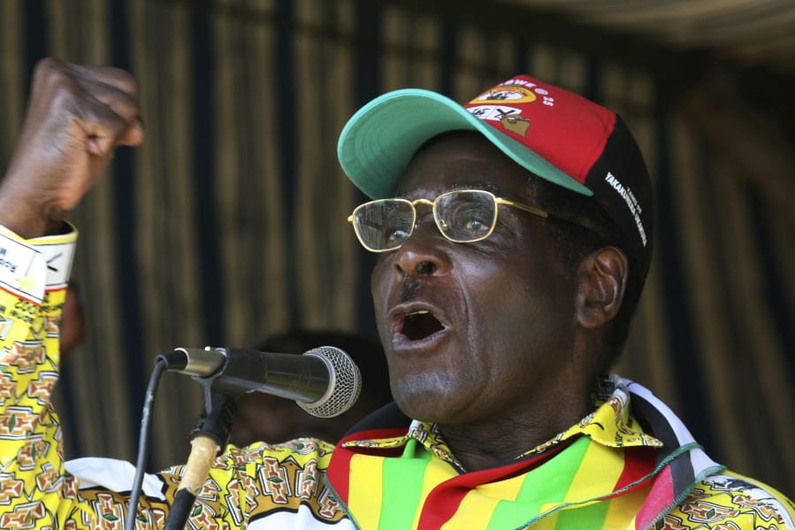 FILE - In this Tuesday, March 18, 2008 file photo, Zimbabwe President Robert Mugabe addresses party supporters at a rally in Gweru, about 250 kms. (155 miles) south of Harare. On Friday, Sept. 6, 2019, Zimbabwe President Emmerson Mnangagwa said his predecessor Robert Mugabe, age 95, has died.