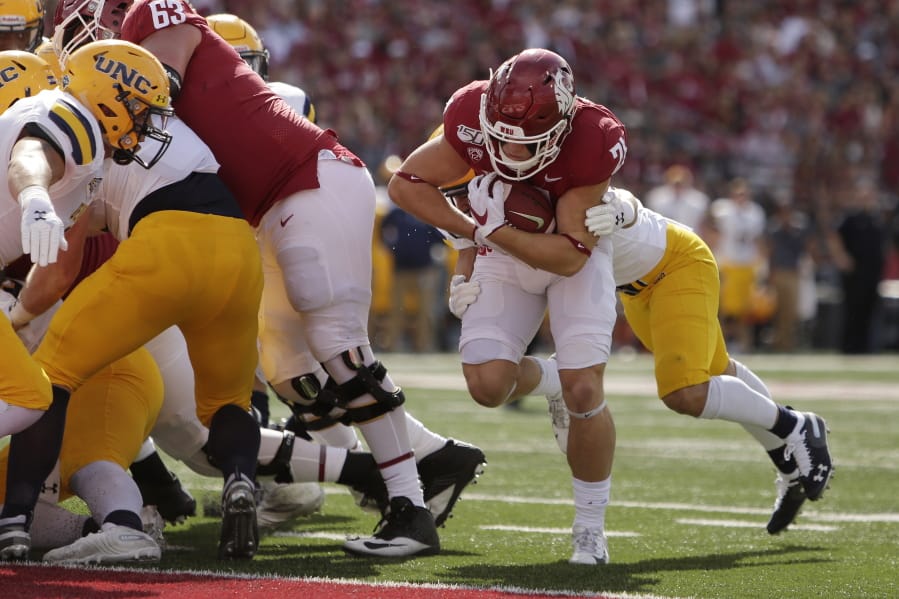 Washington State running back Max Borghi, second from the right, runs for a touchdown while defended by Northern Colorado defensive back Aaron Harris during the first half of an NCAA college football game in Pullman, Wash., Saturday, Sept. 7, 2019.