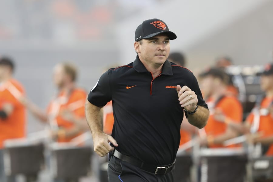 Oregon State coach Jonathan Smith runs onto the field for the team’s NCAA college football game against Oklahoma State in Corvallis, Ore., Friday, Aug. 30, 2019.