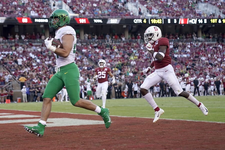 Oregon tight end Jacob Breeland (27) scores a touchdown past Stanford safety Malik Antoine (3) during the second half of an NCAA college football game on Saturday, Sept. 21, 2019, in Stanford, Calif.