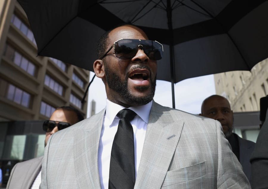 FILE - In this June 6, 2019, file photo, musician R. Kelly leaves the Leighton Criminal Court building in Chicago. Prosecutors say the jailed singer has been moved into the general inmate population despite concern other inmates could try to hurt him because of his celebrity status and because he is accused of sexually assaulting minors. He faces sexual misconduct charges in Illinois, Minnesota and New York.