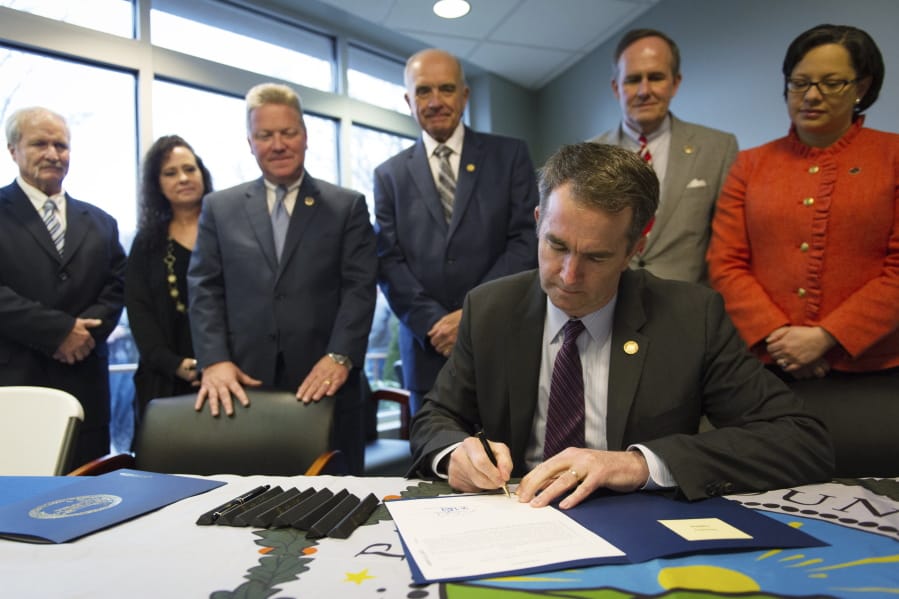 In this Feb. 16, 2018 photo provided by the Office of the Governor of Virginia, Virginia Gov. Ralph Northam signs Senate Bill 866 into law at Pioneer Community Hospital in Stuart, Va. About two years ago, the rural, mountainous Virginia county lost its only hospital, and local officials have now all but given up trying to bring it back. Northam signed bipartisan emergency legislation intended to help the Pioneer Community Hospital reopen. But in recent interviews, community leaders say they have moved on to seeking other ways to improve health care services in a county that sorely needs it.