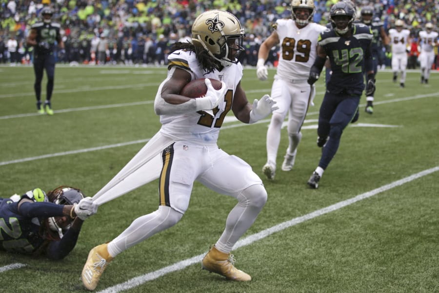 Seattle Seahawks&#039; Shaquill Griffin, left, grabs hold of a piece of uniform as he tries to stop New Orleans Saints&#039; Alvin Kamara on a run during the second half of an NFL football game Sunday, Sept. 22, 2019, in Seattle.