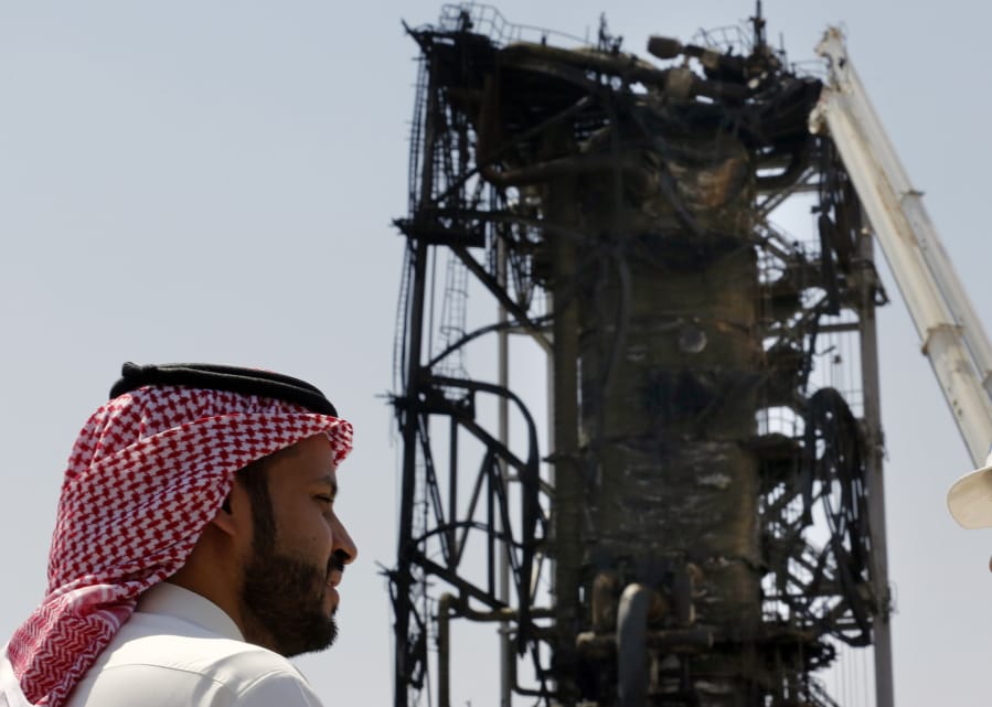 In this photo opportunity during a trip organized by Saudi information ministry, a man watches the damaged in the Aramco&#039;s Khurais oil field, Saudi Arabia, Friday, Sept. 20, 2019, after it was hit during Sept. 14 attack. Saudi officials brought journalists Friday to see the damage done in an attack the U.S. alleges Iran carried out.