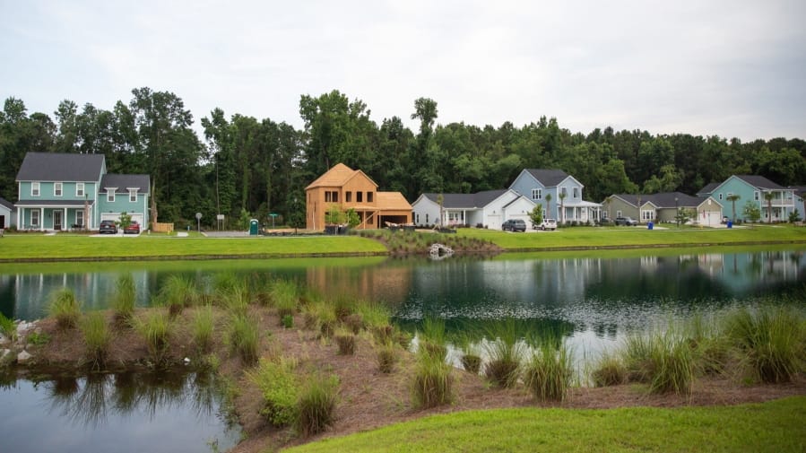 This June 7, 2019 photo, shows the Stonoview development on Johns Island, near Charleston, South Carolina, where builders are required to build retention ponds to store rainwater and prevent flooding. Johns Island residents have opposed such dense developments out of fear that they will worsen the flooding. Developments in disaster prone areas means big bucks for builders, but leaves homeowners in some communities at risk.