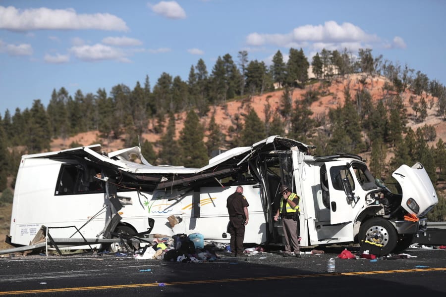 Authorities work the scene where at least four people were killed in a tour bus crash near Bryce Canyon National Park, Friday, Sept. 20, 2019, in Utah.