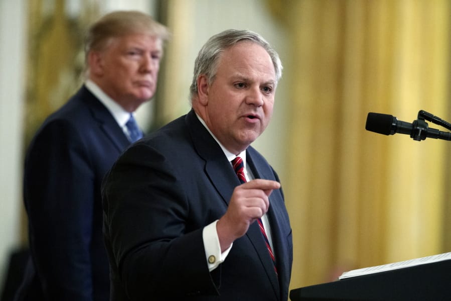 FILE - In this July 8, 2019, file photo President Donald Trump listens as then-Secretary of the Interior David Bernhardt speaks during an event on the environment in the East Room of the White House in Washington. In less than three years, Trump has named more former lobbyists to Cabinet-level posts than his most recent predecessors did in eight, putting a substantial amount of oversight in the hands of people with ties to the industries they&#039;re regulating.