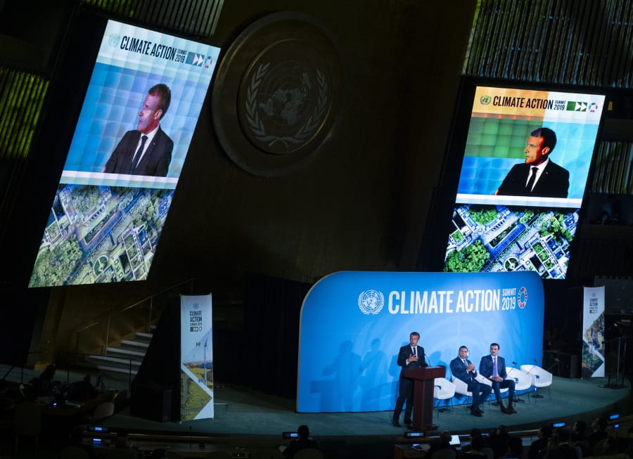 French President Emmanuel Macron speaks during the Climate Action Summit 2019 at the 74th session of the United Nations General Assembly, at U.N. headquarters, Monday, Sept. 23, 2019. Emir of Qatar, Sheikh Tamim bin Hamad Al Thani is center and Jamaica Prime Minister Andrew Holness is right.