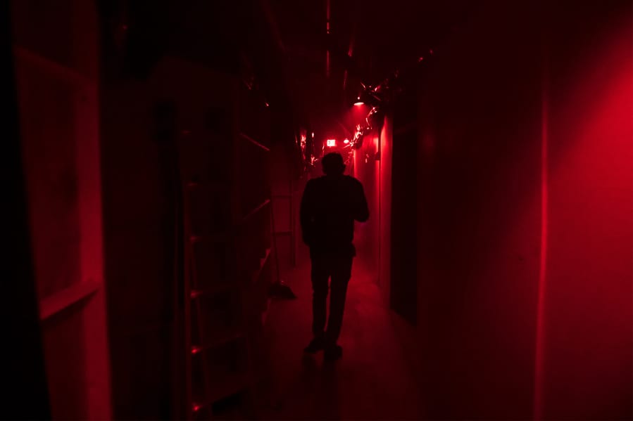 Jason Greeley-Roberts, an owner of the Clark County Scaregrounds, walks through an access corridor behind one of his haunts while checking on the actors in 2018. Scaregrounds takes place at Clark County Fairgrounds through Halloween.