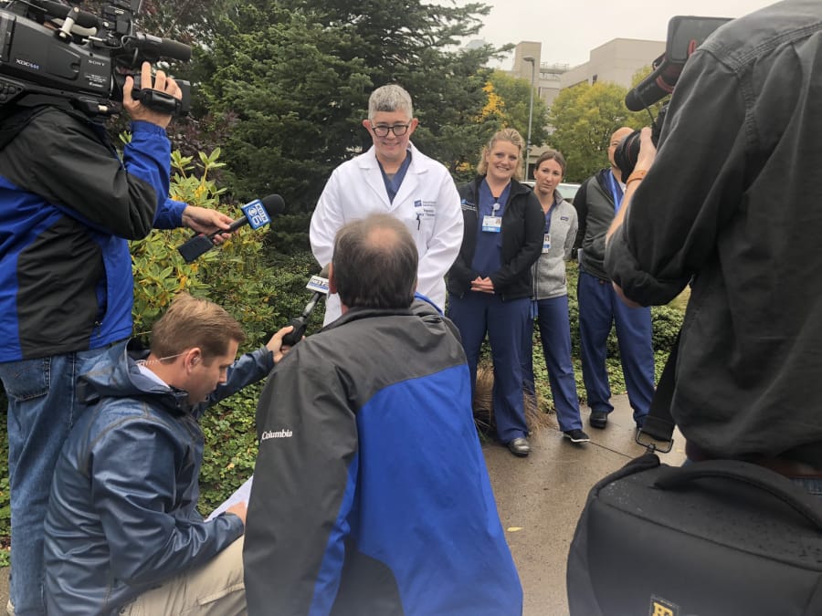 Dr. Tracy Timmons, head surgeon of the trauma center at PeaceHealth Southwest Medical Center in Vancouver, and her team speak to members of the media following Thursday's shooting at Smith Tower Apartments in downtown Vancouver. Two patients were transported to the hospital from the scene, where they were in satisfactory condition later that afternoon.