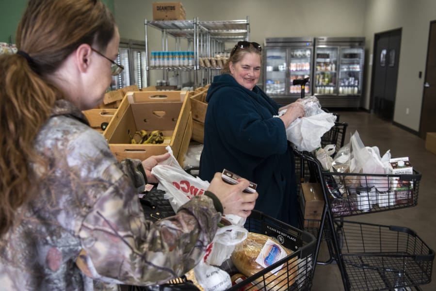 Karen Dickerson, left, and her mother Mary Harriman recently began visiting Community Kitchen, a food pantry in Fruit Valley. Harriman said she looks for foods that can go together to create a meal.