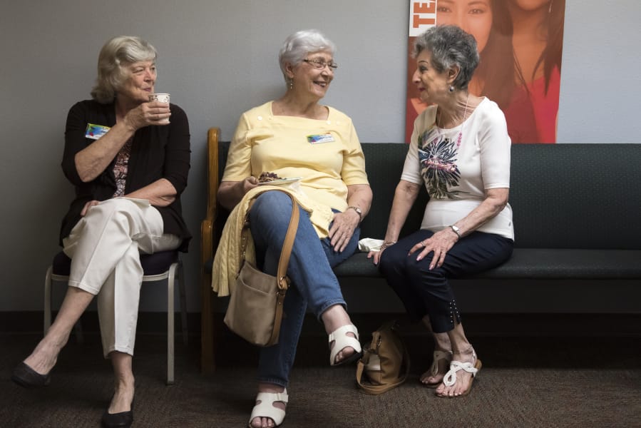 Lyn Farr, from left, Dorie Dageforde and Marian Sandler catch up before September's general meeting of the Clark County Newcomers Club at the YWCA Clark County.