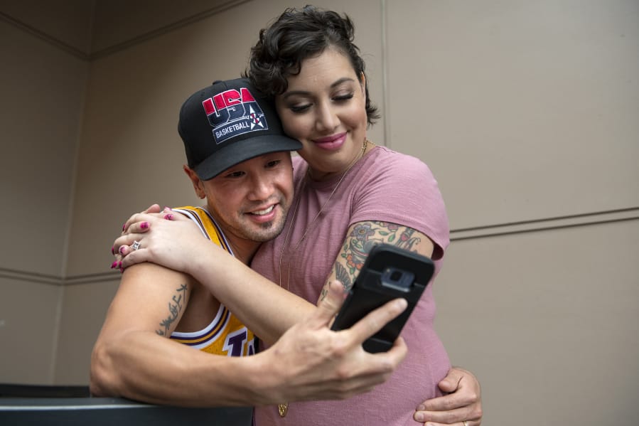 Ryuichi Ohyama, left, poses for a selfie with Tearra Flippo on the balcony at Flippo&#039;s Vancouver apartment during her cancerversary party in September to celebrate the one-year anniversary of the end of active breast cancer treatment. Flippo asked Ohyama to marry her last year. He said yes. She has plans to move to California and live with him.