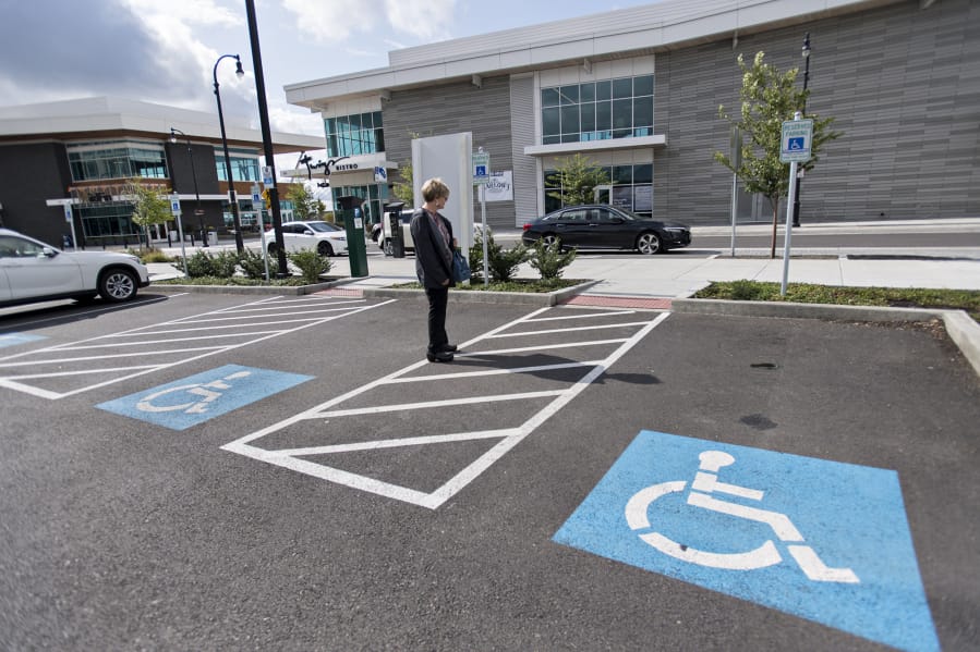 Helen Engel of Vancouver checks out the wheelchair-accessible parking spaces across from Twigs Bistro and Martini Bar at The Waterfront Vancouver.