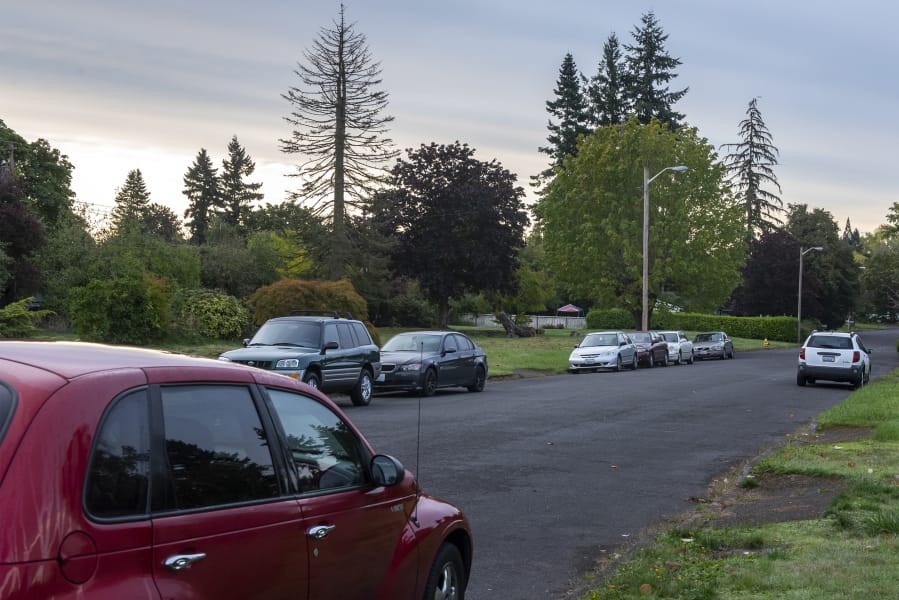 Cars are parked at the corner of Northeast Fifth Street and Northeast 94th Avenue near Henrietta Lacks Health and Bioscience High School on Monday morning. Residents in the neighborhood say traffic in the neighborhood has become progressively worse since the school opened in 2013.