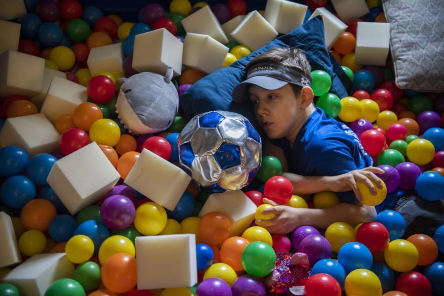 Emmett Elliott, 10, plays in his ball pit at home in Vancouver. Emmett was diagnosed with a rare neurological disorder called Jordan's Syndrome earlier this year. The disorder can cause intellectual delay, hypotonia, or low muscle tone, impaired speech, developmental delays, autism spectrum disorder and seizures.