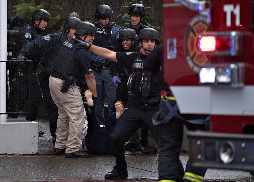 Police from multiple agencies carry a wounded woman after a shooting at Smith Tower Apartments on Thursday afternoon, Oct. 3, 2019.