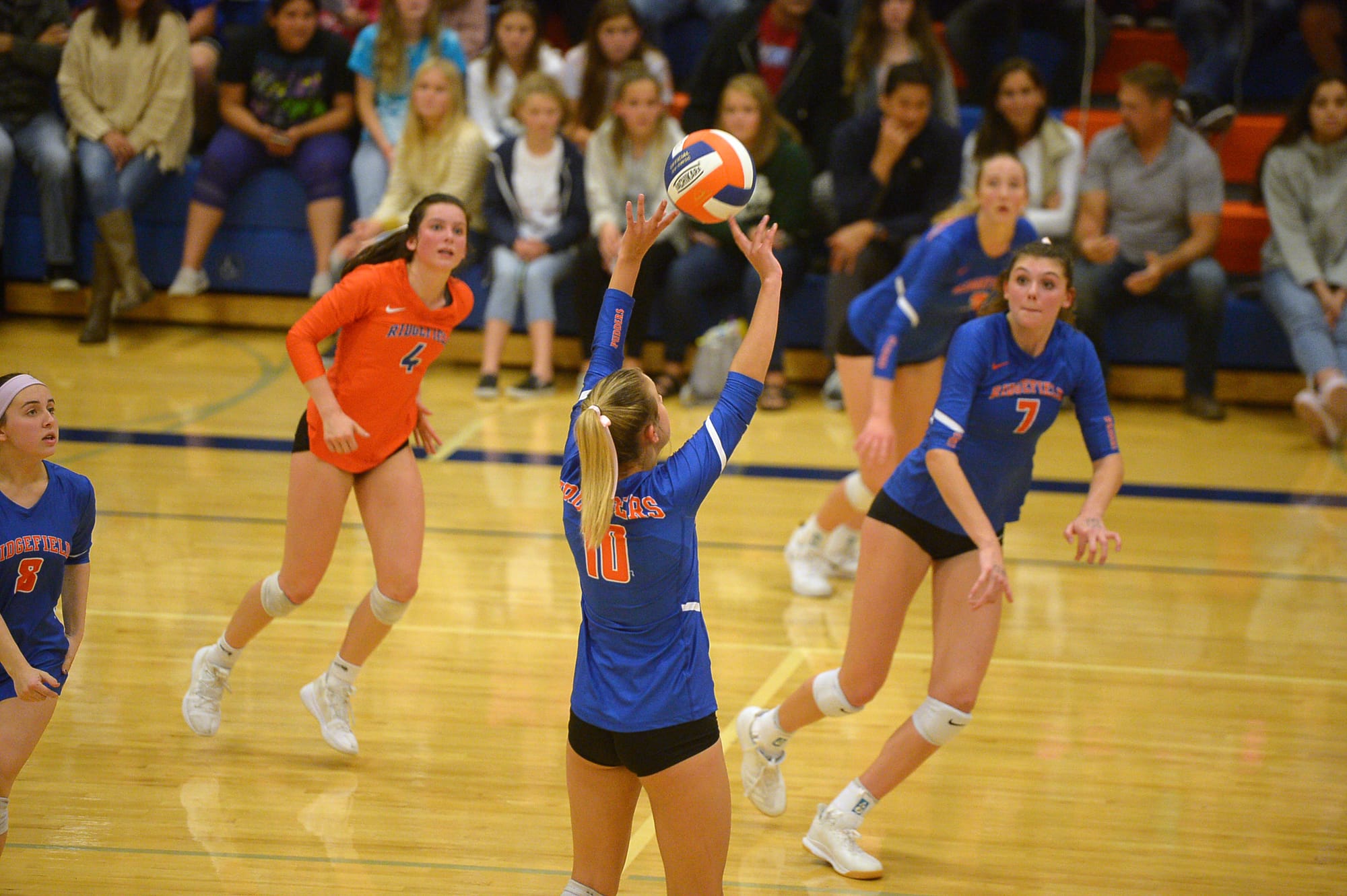 Ridgefield junior Morgan Harter sets the ball for teammate Alicia Andrew during a game against Columbia River at Ridgefield High School on Tuesday, October 8, 2019. Ridgefield won all three sets against Columbia River.