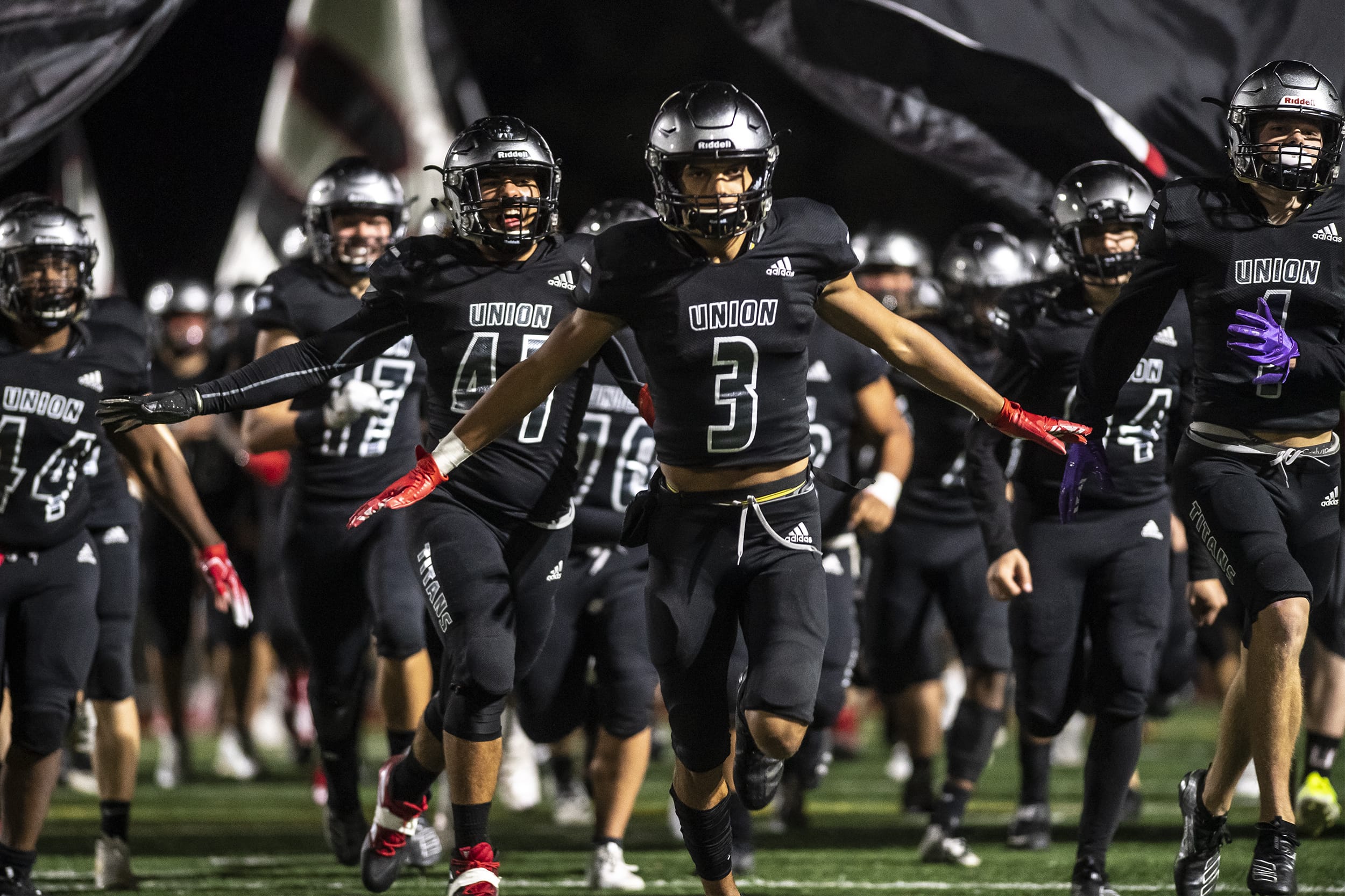 The Union Titans run onto the field after halftime during a game against Skyview at McKenzie Stadium on Friday night, Oct. 11, 2019.