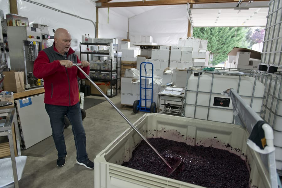 Don Klase mixes wine in a vineyard at Dolio Winery in Battle Ground.