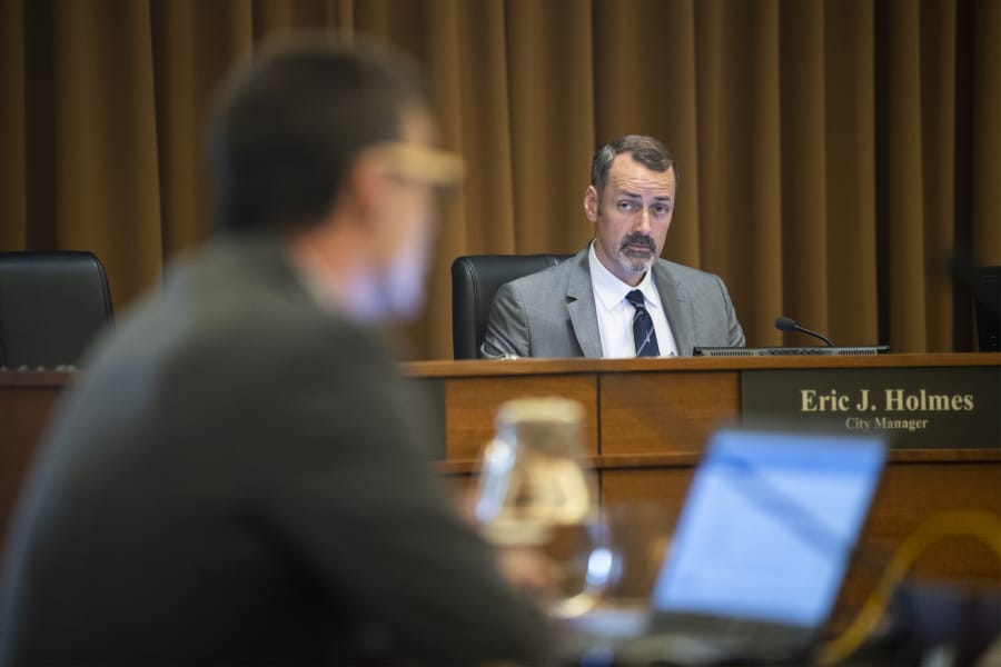 Vancouver City Manager Eric Holmes listens to council deliberations during a city council work session on Monday. Holmes is the highest-paid city employee in the greater Portland metro area.