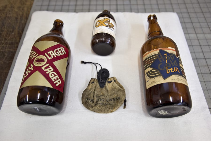A few historical beer bottles, including one from 1918, right, wait to be displayed at the Clark County Historical Museum. The items needed to be cleaned and assessed by James Kice before display.