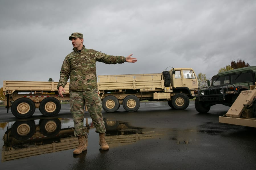 Cmdr. Josh Barrow provides an overview of Bravo Company&#039;s vehicles during an open house at the Armed Forces Reserve Center on Saturday afternoon.