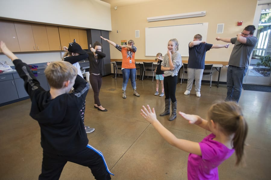 Rachel Jensen, 11, of Vancouver, center, watches as fellow acting students strike a pose during a class for home-schooled kids at the Firstenburg Community Center on Thursday morning. Firstenburg began offering the home-school classes in September, offering supplemental programming to students who are not in traditional school settings.
