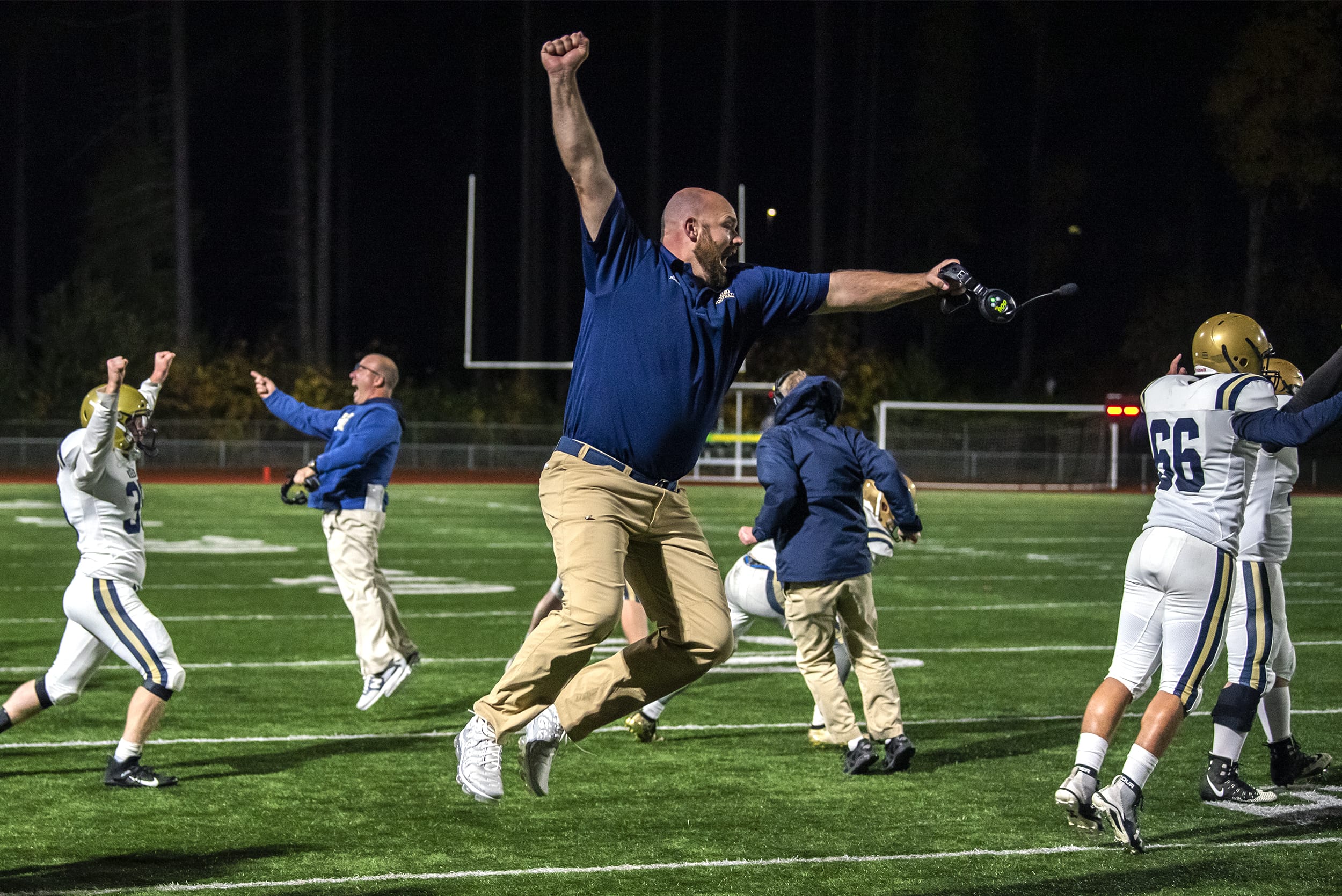Kelso Assistant Coach Brad Phillips celebrates with the rest of his team after a fumble recovery secured victory over Mountain View during a game at McKenzie Stadium on Friday night, Oct. 25, 2019.