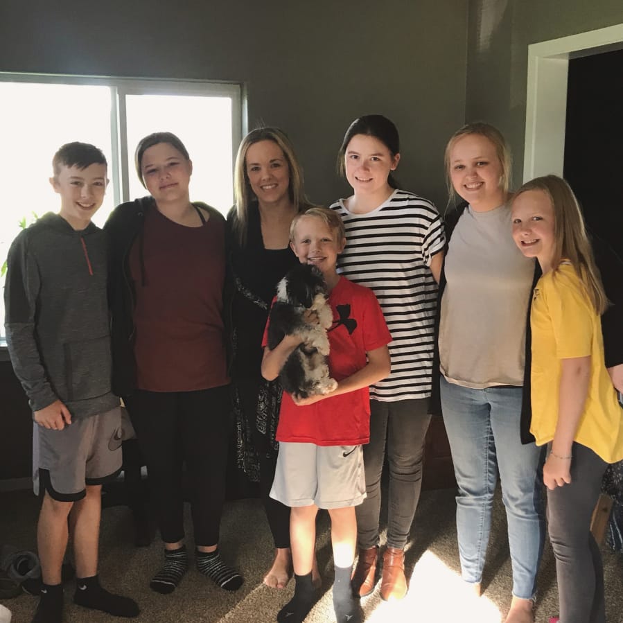 Ashley Eggleston, center, credits her three kids and three teenagers with saving her life after her heart stopped earlier this month. The teens called 911, started CPR and comforted her kids while first responders worked on her. From left: Owen Meyer, Emilee Tikka, Eggleston, Evan Meyer, Kate Nylund, Eva Sarkinin and Nora Meyer.