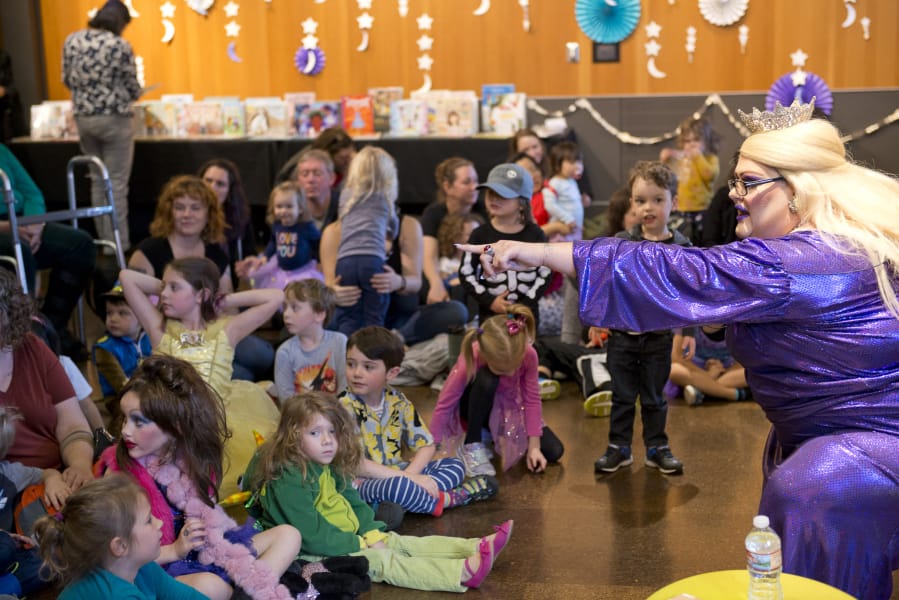 Drag queen Tree Empress 45 Onalicious Mercury asks kids what they want to be when they grow up Sunday at the Drag Queen Story Hour at the Vancouver Community Library. More than 100 children and parents attended the event to sing, dance and listen to storybooks.