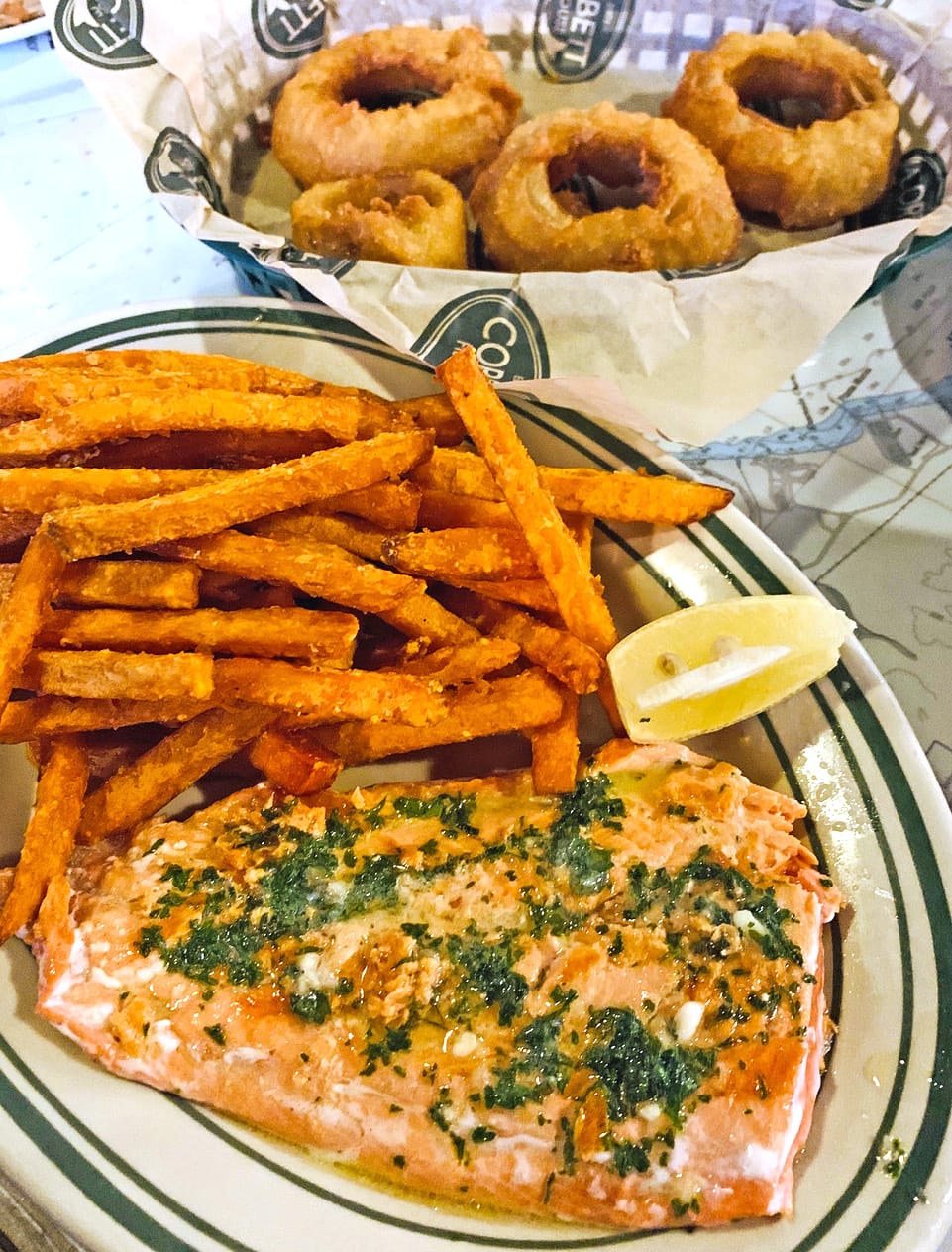Grilled sockeye salmon, sweet potato fries and onion rings at Corbett Fish House.