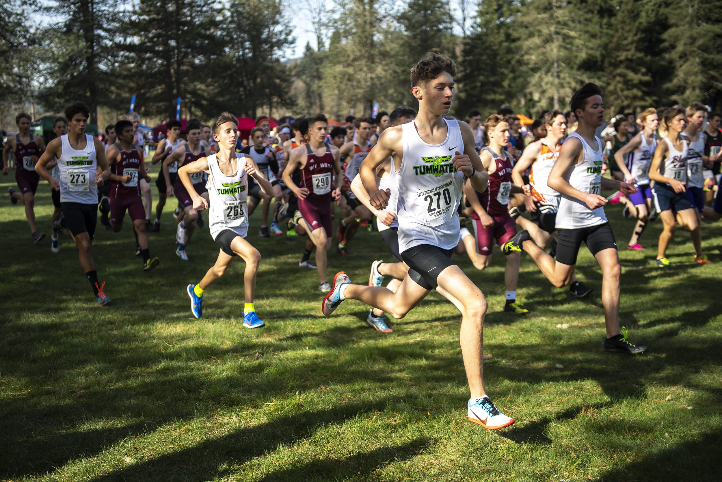 Runners take off from the starting line during the 2A Boys District Cross Country meet at Lewis River Golf Course on Thursday afternoon, Oct. 31, 2019.