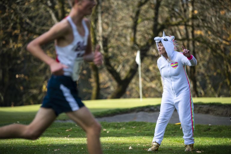Maryann Keyser cheers on Washougal runners during the 2A Boys District Cross Country meet at Lewis River Golf Course on Thursday afternoon, Oct. 31, 2019.