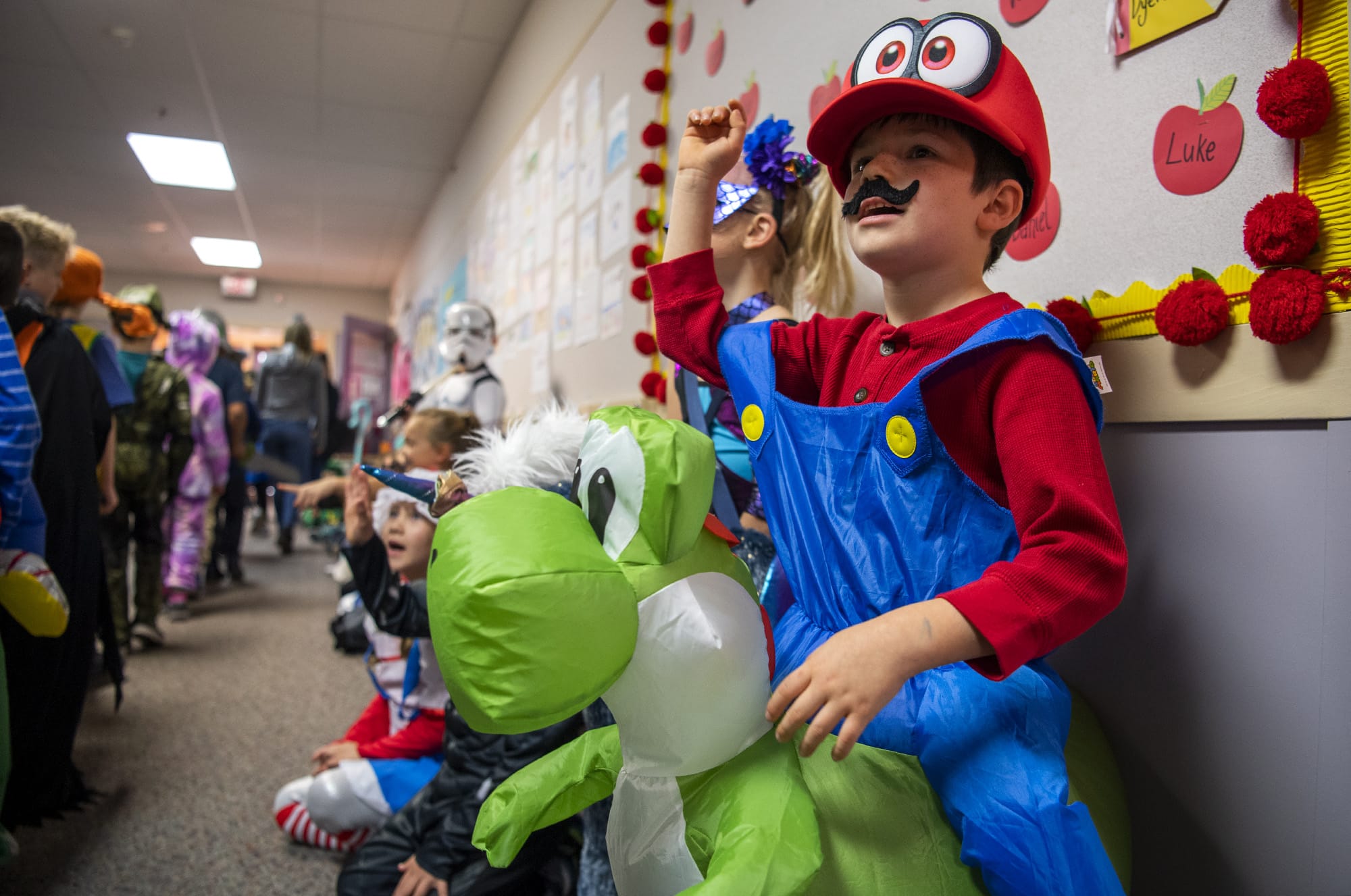 Hathaway Elementary School first-grader Joshue Rivera dresses as Mario and Yoshi during a Halloween parade at the school in Washougal on Oct. 31, 2019.