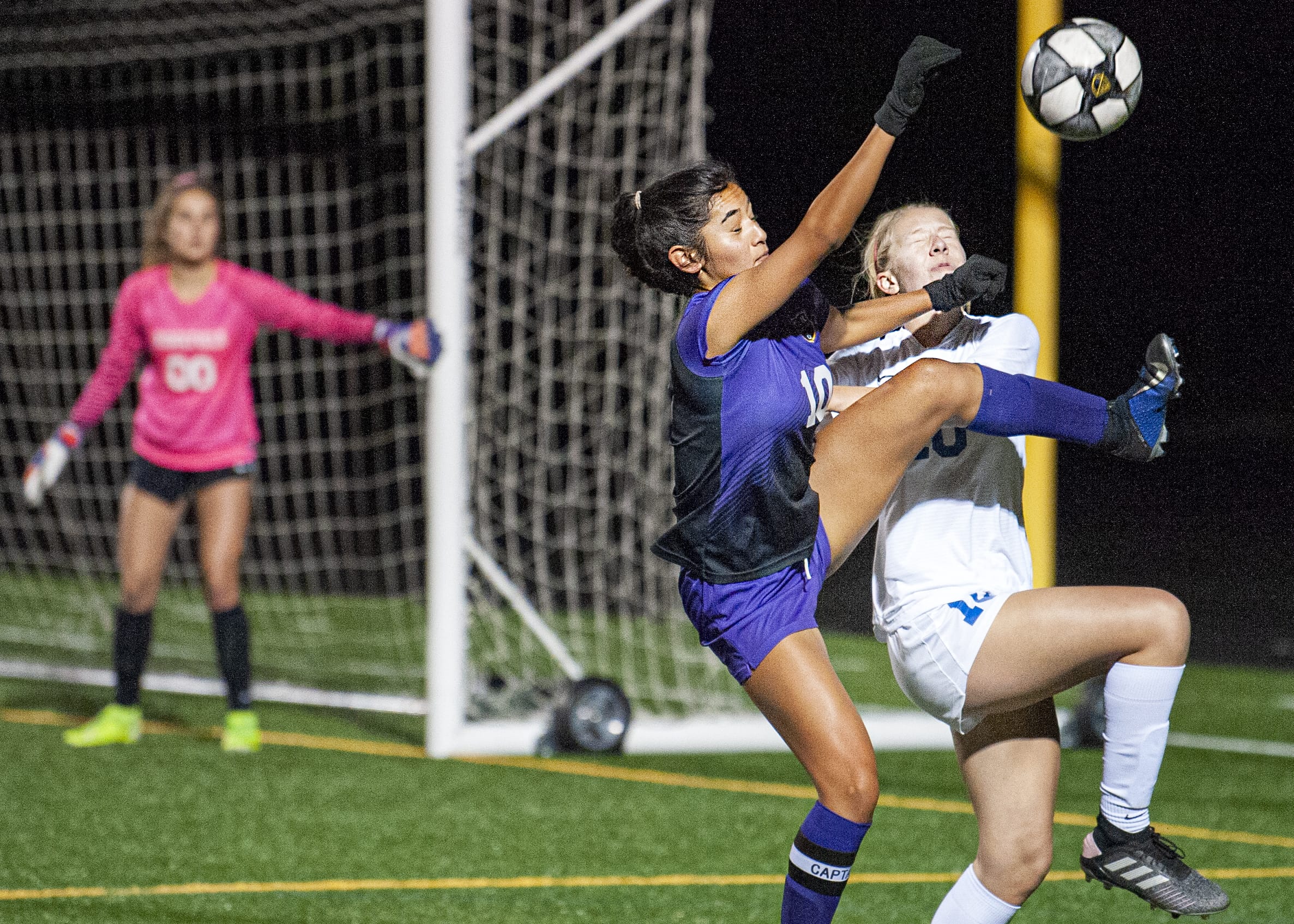 Columbia River’s Yaneisy Rodriguez, front, tries to win a ball against Ridgefield’s Jaynie Murray in the Chieftains’ 2-1 win on Tuesday at Chieftain Stadium.