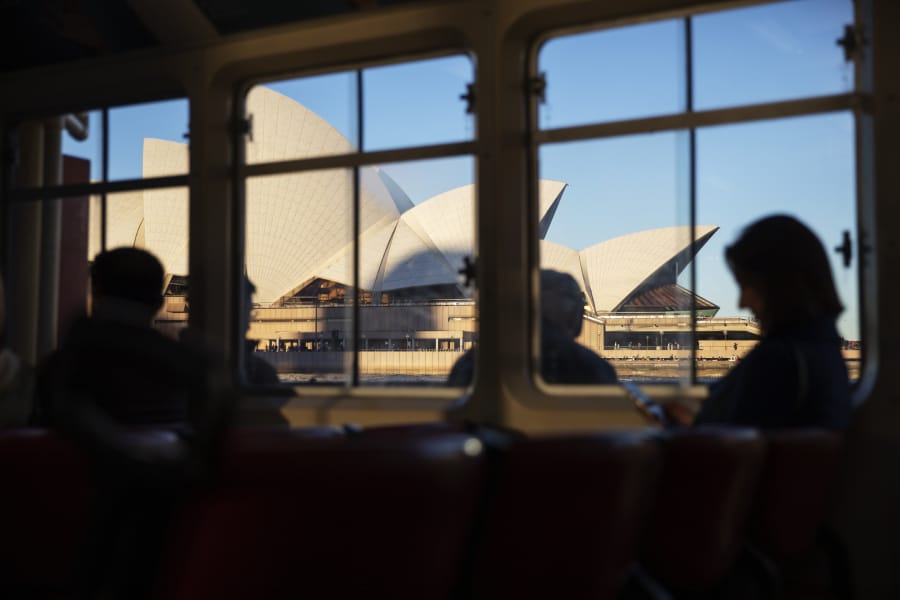 Ferry passengers sail past the Sydney Opera House in Sydney, Australia. The opera house came in more than 1,300 percent over budget, but has become one of the world's most recognizable structures.