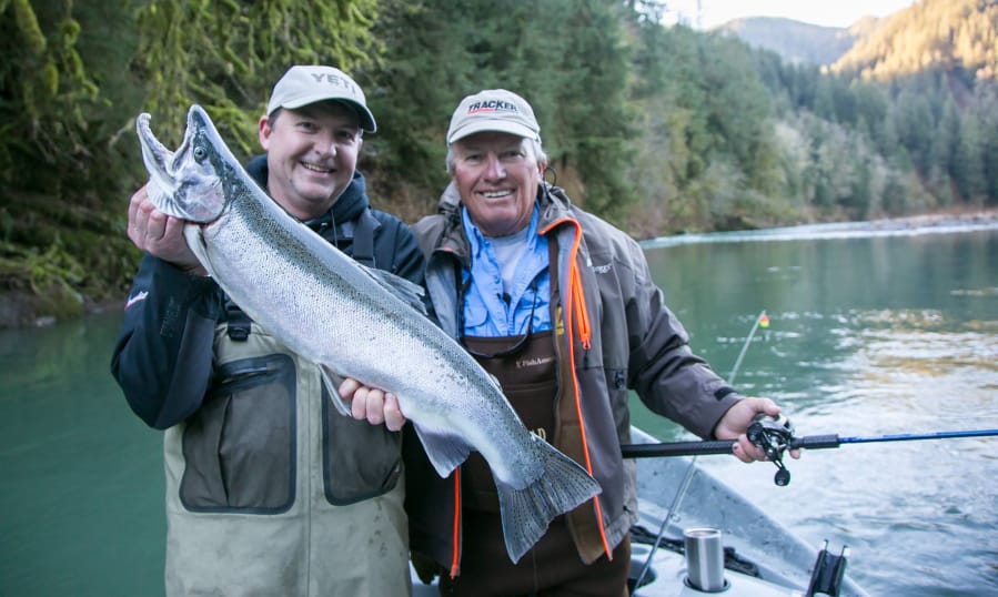 Justin Wolff, (left), the host of Angler West TV, poses with a steelhead while the legendary fisherman Roland Martin looks on. Wolff&#039;s tackle shop in Woodland stocks products and gear used in episodes of his popular show.