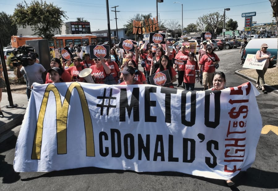 McDonald&#039;s workers carry a banner and march towards a McDonald&#039;s in south Los Angeles in 2018.