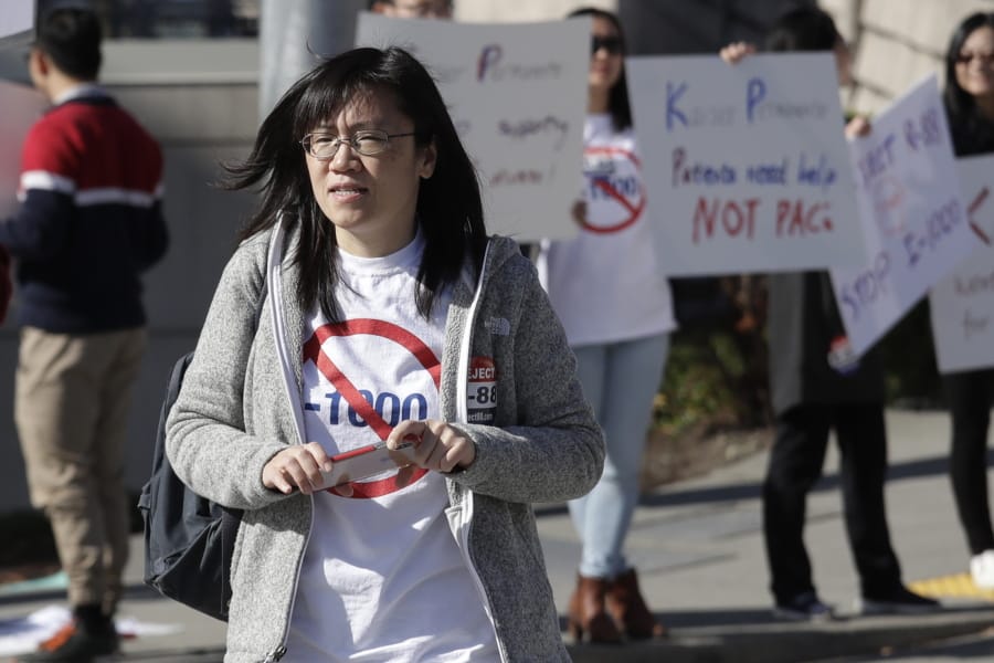 In this photo taken Oct. 11, 2019, Linda Yang, of the &#039;Let People Vote&#039; campaign, is seen at a demonstration against I-1000, in Bellevue, Wash. More than two decades after Washington voters banned affirmative action, the question of whether one&#039;s minority status should be considered as a contributing factor in state employment, contracting and admission to public colleges and universities is back on the ballot. The Nov. 5 vote comes months after the Legislature approved Initiative 1000 in April, on the final day of this year&#039;s legislative session. Opponents of the measure collected enough signatures to force a referendum, Referendum 88, and now voters will have the final say on whether I-1000 should become law.