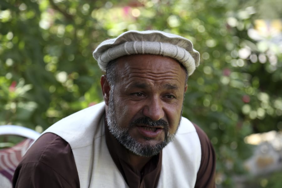 Aziz Rahman, a village elder who had contracted the farmers to harvest the pine nuts, speaks Tuesday during an interview to the Associated Press in Jalalabad city east of Kabul, Afghanistan.