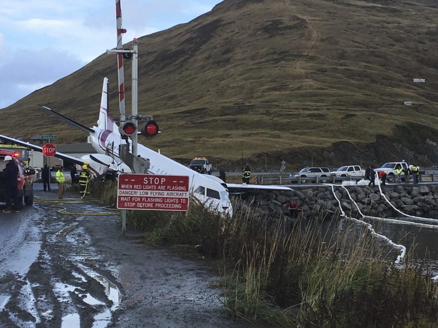 A commuter airplane has crashed near the airport in a small Alaska community on the Bering Sea, Thursday, Oct. 17, 2019, in Unalaska, Alaska. Freelance photographer Jim Paulin says the crash at the Unalaska airport occurred Thursday after 5 p.m. Paulin says the Peninsula Airways flight from Anchorage to Dutch Harbor landed about 500 feet (152 meters) beyond the airport near the water.