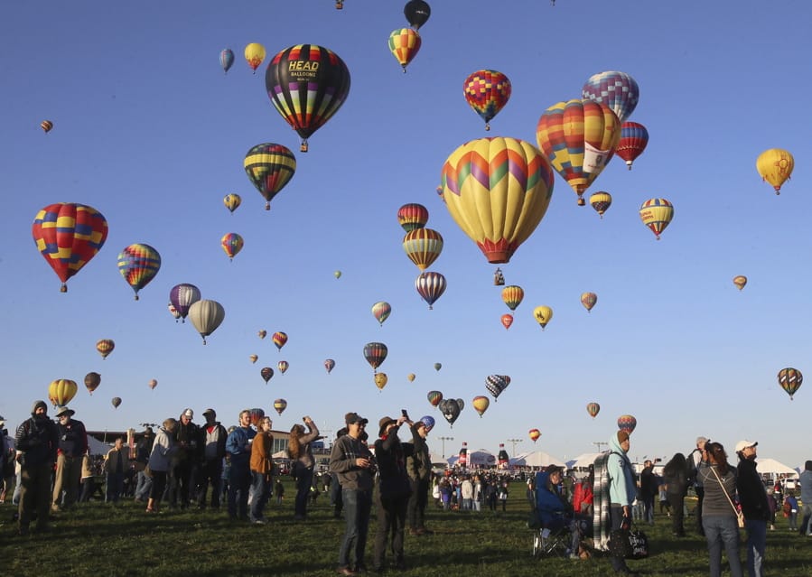 Spectators watch hot air balloons liftoff at the Albuquerque International Balloon Fiesta in Albuquerque, N.M., Sunday, Oct. 6, 2019.