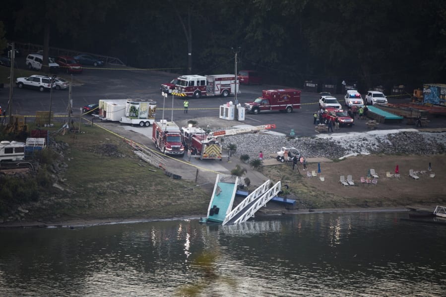 Emergency personnel respond after a barge struck the Ludlow Bromley Yacht Club in Ludlow, Ky., on Wednesday, Oct. 2, 2019.