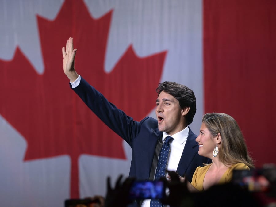 Liberal leader Justin Trudeau and wife Sophie Gregoire Trudeau wave as they go on stage at Liberal election headquarters in Montreal, Monday, Oct. 21, 2019.